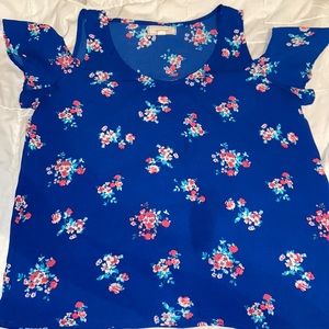 Women's shirt. Royal blue, floral, shoulder cutout. Size medium.